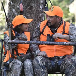 African American father and daughter in treestand