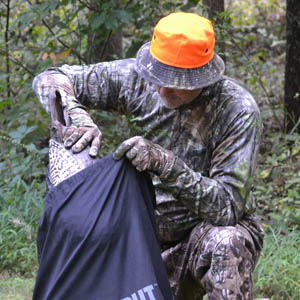 Hunter placing decoy in bag