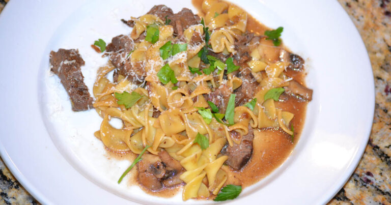 Sliced venison steak with sauteed mushrooms and parmesan cheese.