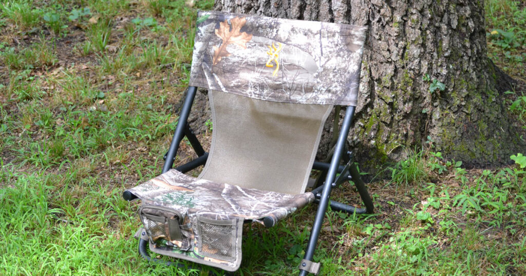 foldable hunting chair against tree