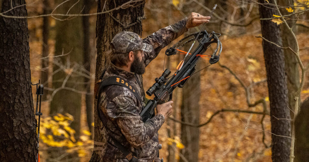 hunter placing arrow on crossbow